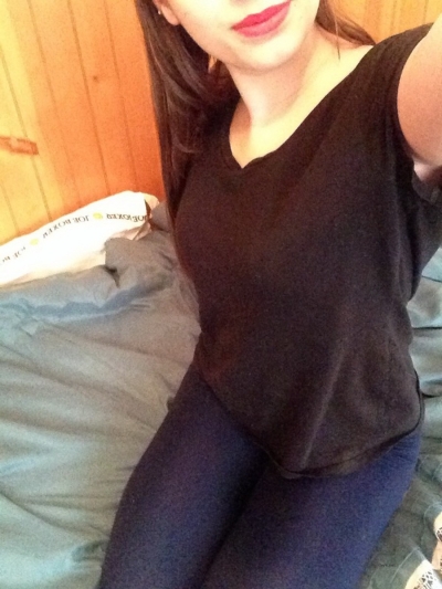 A sexy girl lies on the bed and shows off her naked body.