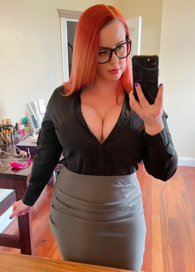 An attractive woman with a great figure who dyed her hair a bright red color