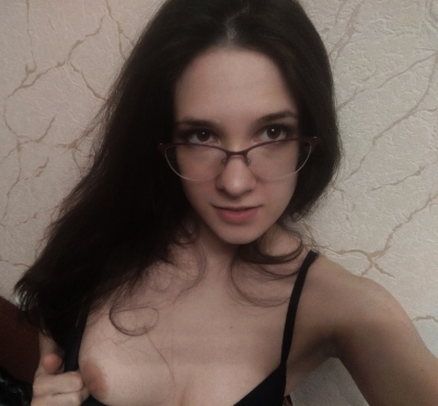 Attractive brunette. A girl with perfect curves poses confidently.