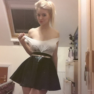 Natural big tits of a girl in a skirt.