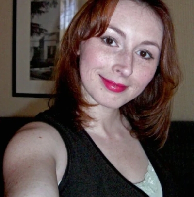 Redhead Ellie with freckles shows her holes