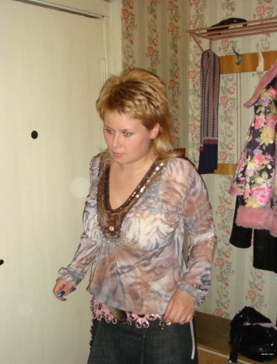 Brown-haired woman takes pictures of her pussy