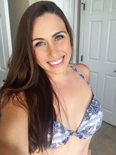 Gorgeous brunette MILF shows off her assets while masturbating