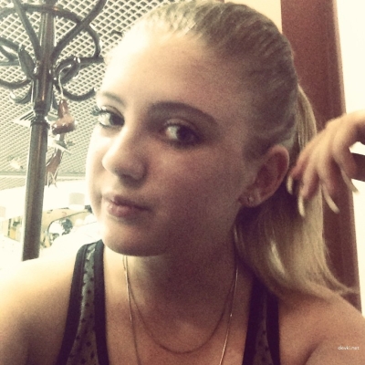 A young girl spreads her legs and shows her pussy close up